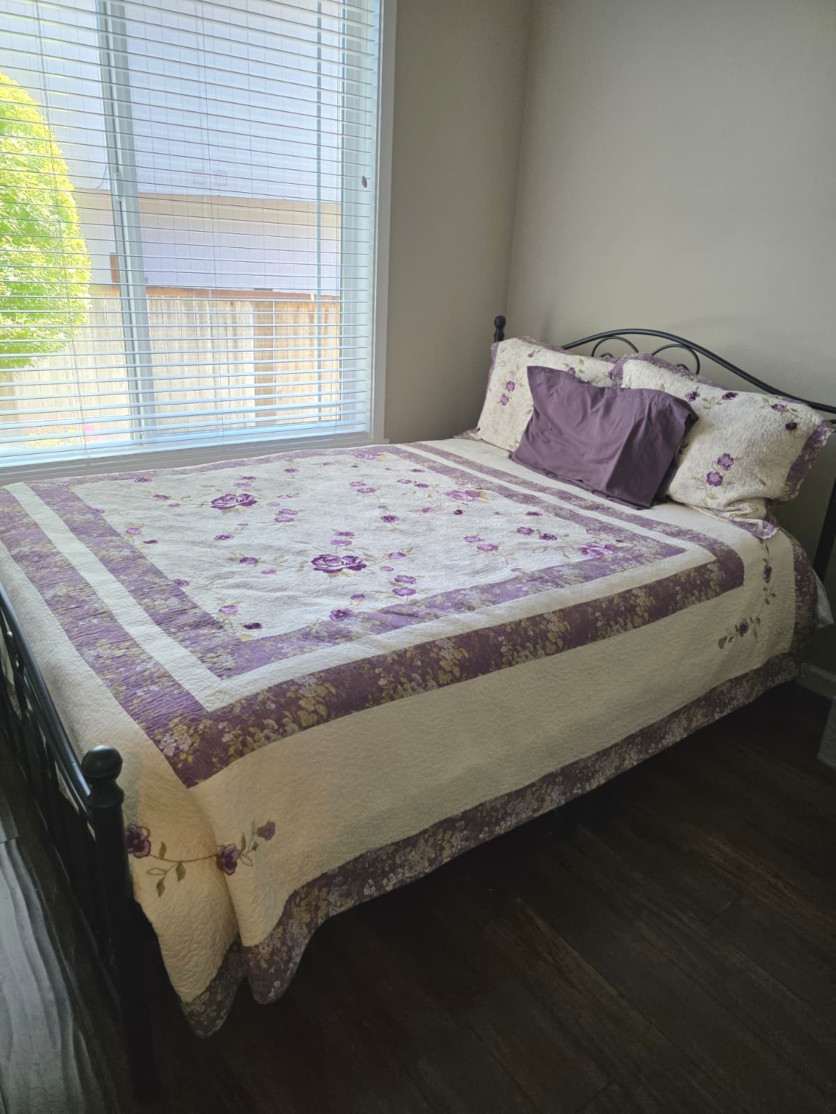 Cozy resident bedroom with floral bedding and purple accents
